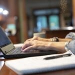 A person uses a laptop computer while working from home.