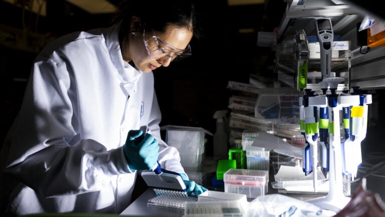 A researcher works in the lab at the Moderna headquarters in Cambridge, Mass.