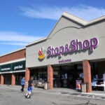 People walk outside a Stop & Shop in Newport, R.I.